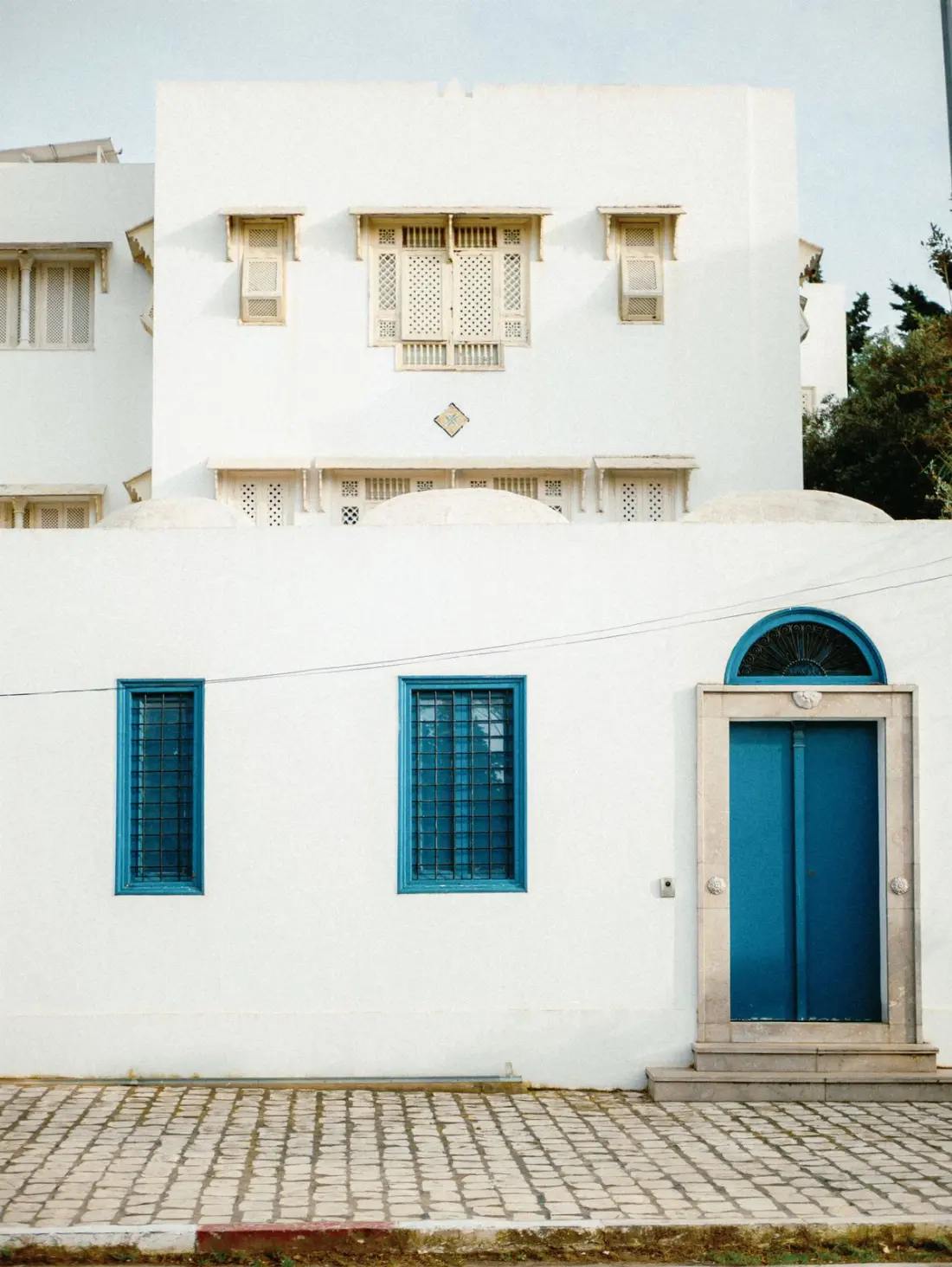 Illustrative photograph: White and blue Mediterranean house exterior in a traditional setting