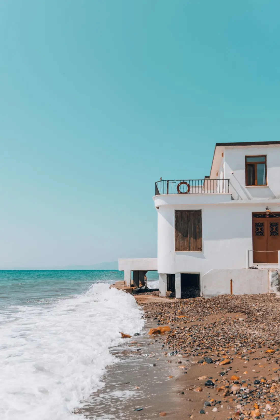 Illustrative photograph: White Mediterranean house beside the sea