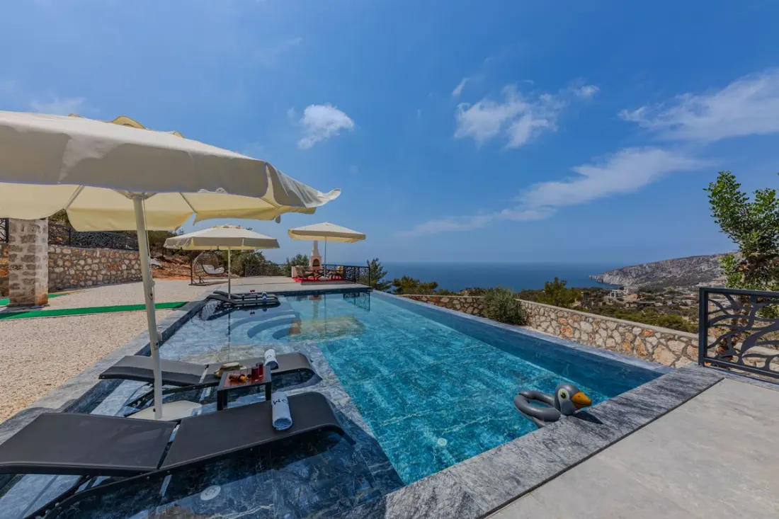 Illustrative photograph: Luxury coastal villa pool with sea view and sun loungers