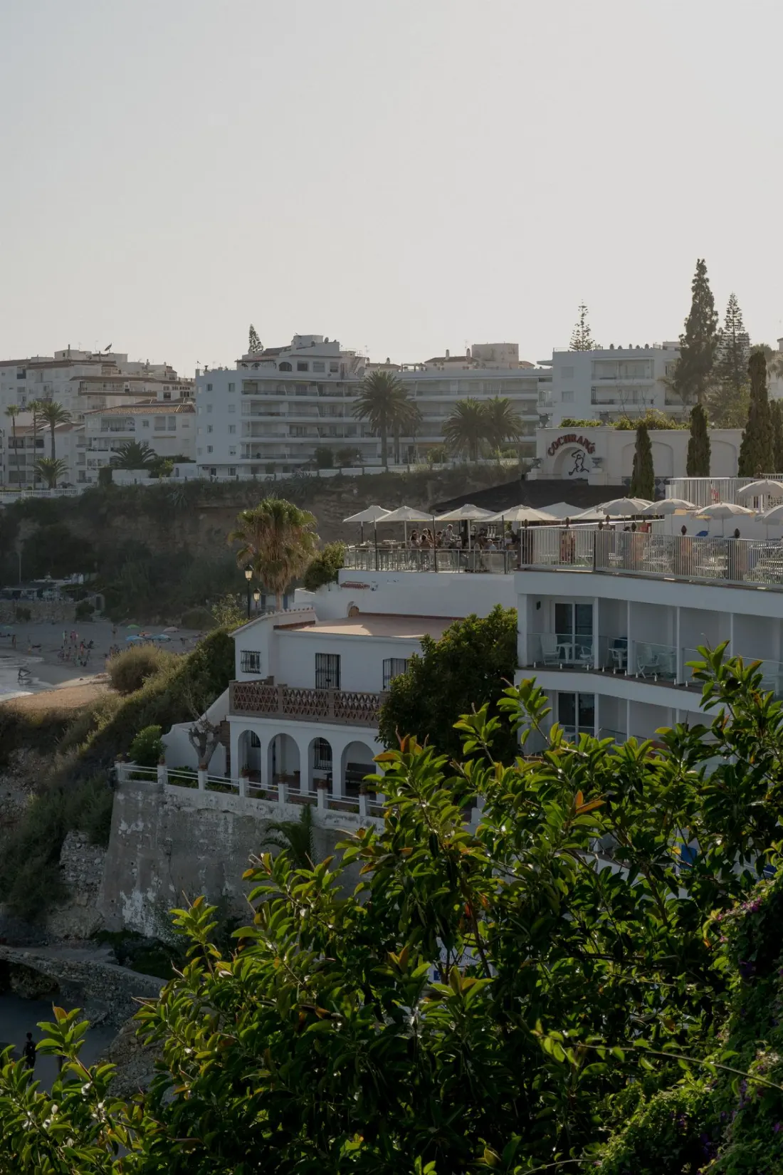 Illustrative photograph: White coastal buildings and terraces in Nerja