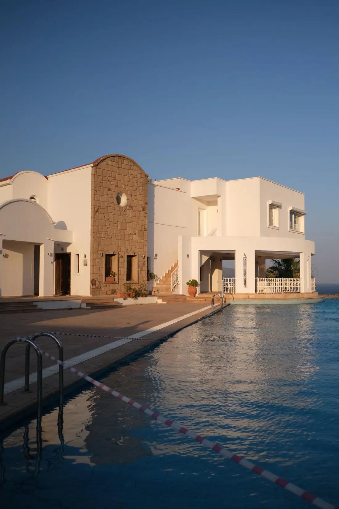Illustrative photograph: Elegant Mediterranean villa with pool at sunset